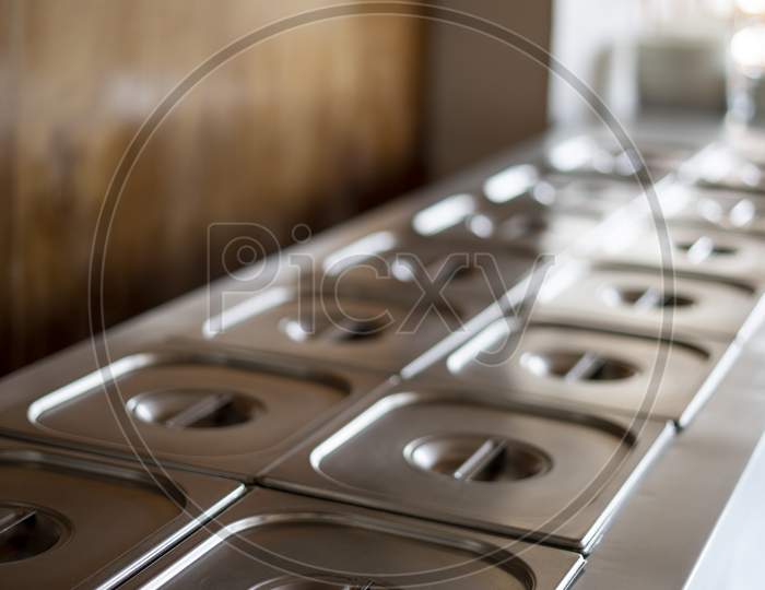 Simple Banquette Buffet Catering Wedding Stainless Steel Chrome-Plated Bowls Closed Lid On Table Blur Focus