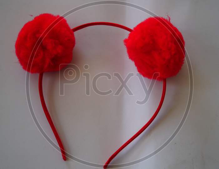 Red Fancy Head Band Or Head Ribbon Closeup Shot With White Background. Hair Care Accessory Concept.