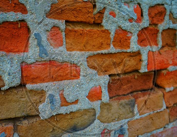 Empty Old Brick Wall Texture. Painted Distressed Wall Surface. Grungy Wide Brick Wall. Grunge Red Stonewall Background.
