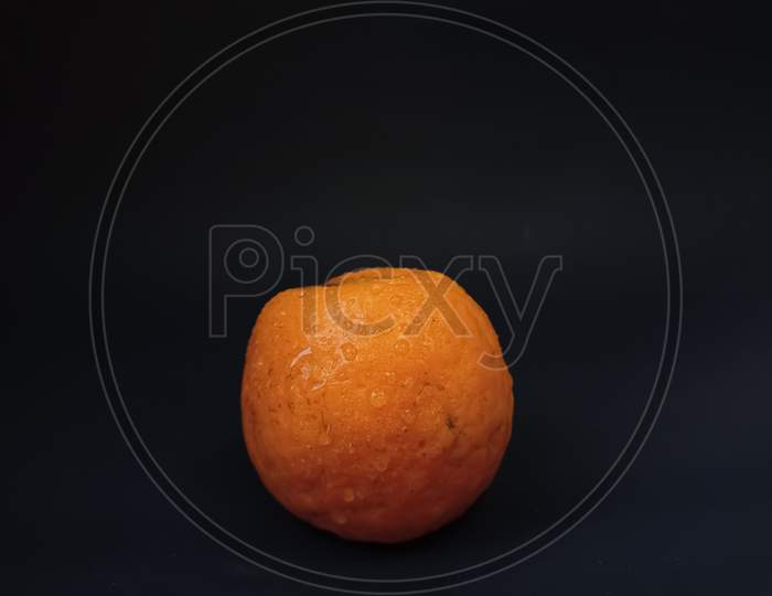Orange fruit on black background