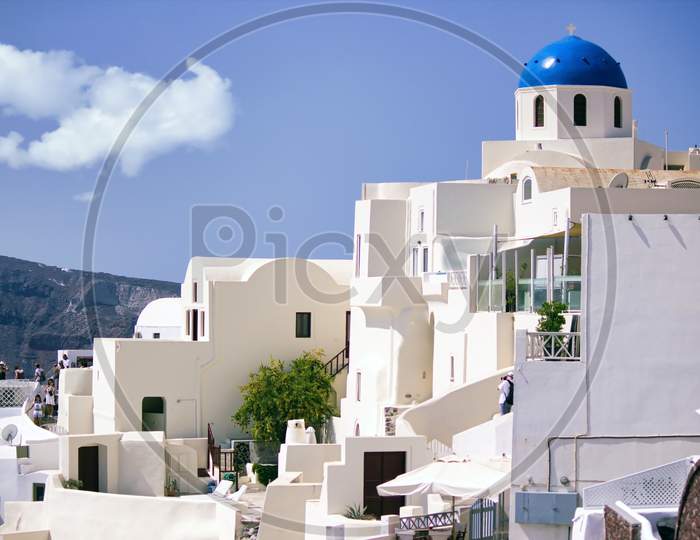 Santorini, Greece - September 11, 2017: Oia Village In Cycladic Architecture Style In Santorini, Greece Against Clear Blue Sky