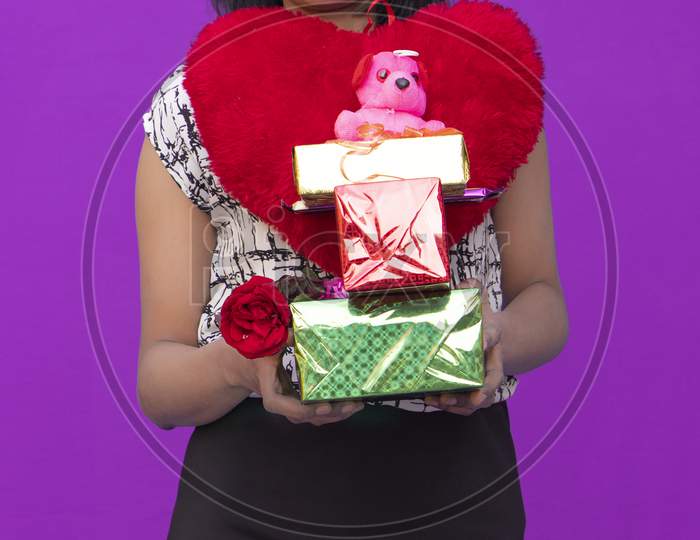 Valentine's Day, A Beautiful girl with a valentine gift and flowers