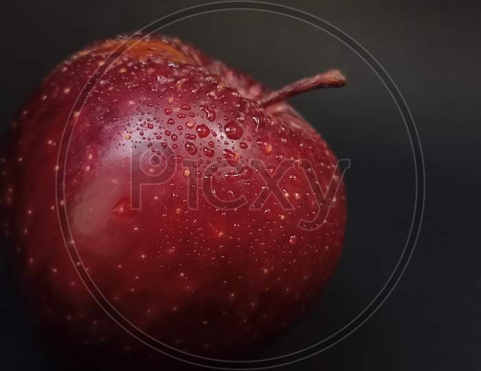 Red apple on black background