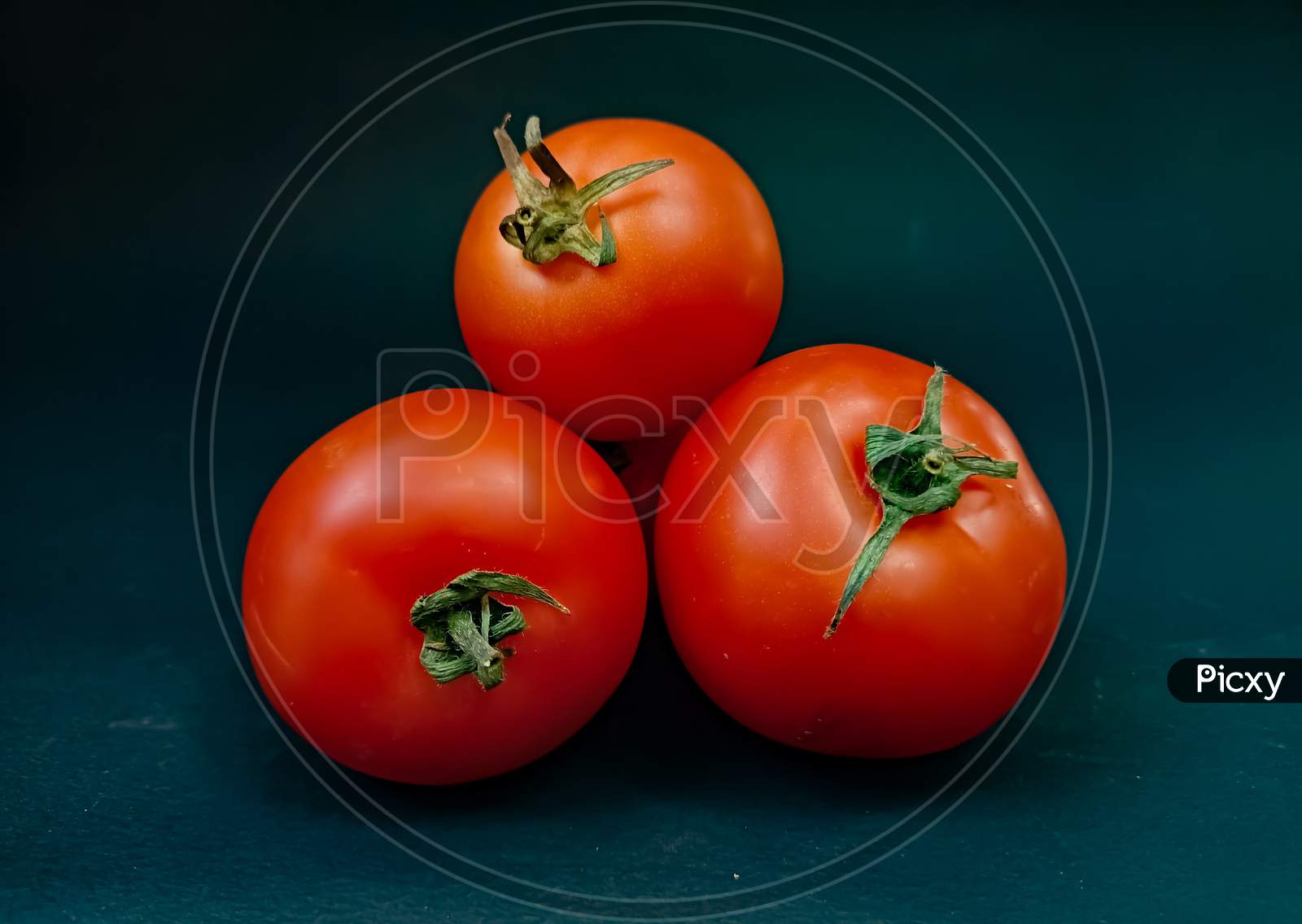 Red tomato on black background