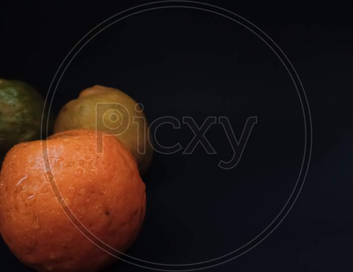 Orange fruit on black background