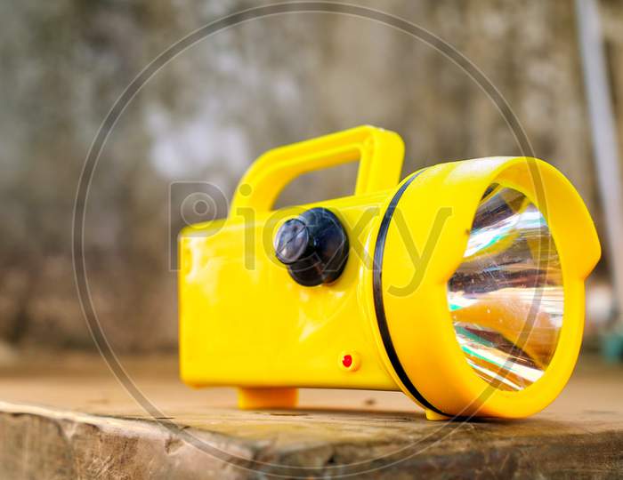 Side View Shot Of Yellow Color Kisan Or Farmer Torch. Battery Mostly Uses In Agriculture Industry To Search In Darkness.