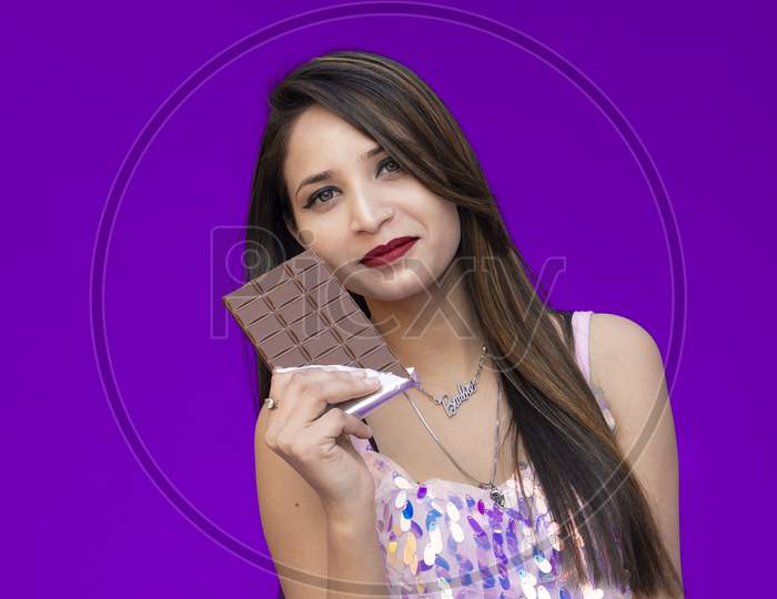 A Beautiful girl poses with chocolate, Chocolate Day