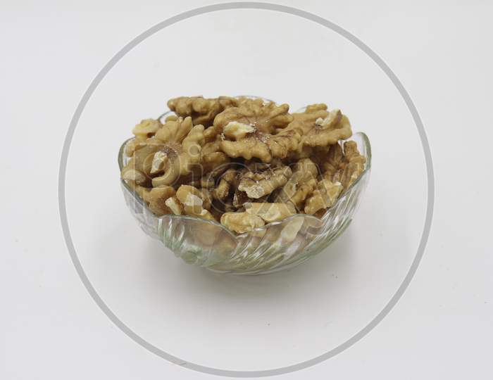 Bowl with tasty walnuts isolated on white background