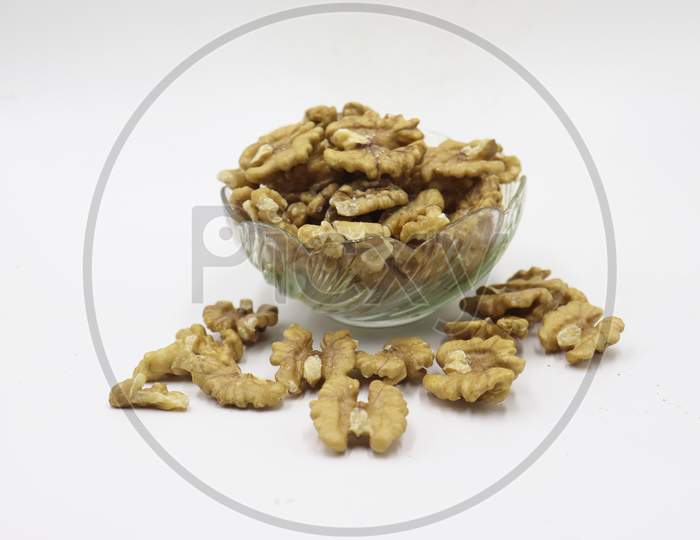 Bowl with tasty walnuts isolated on white background