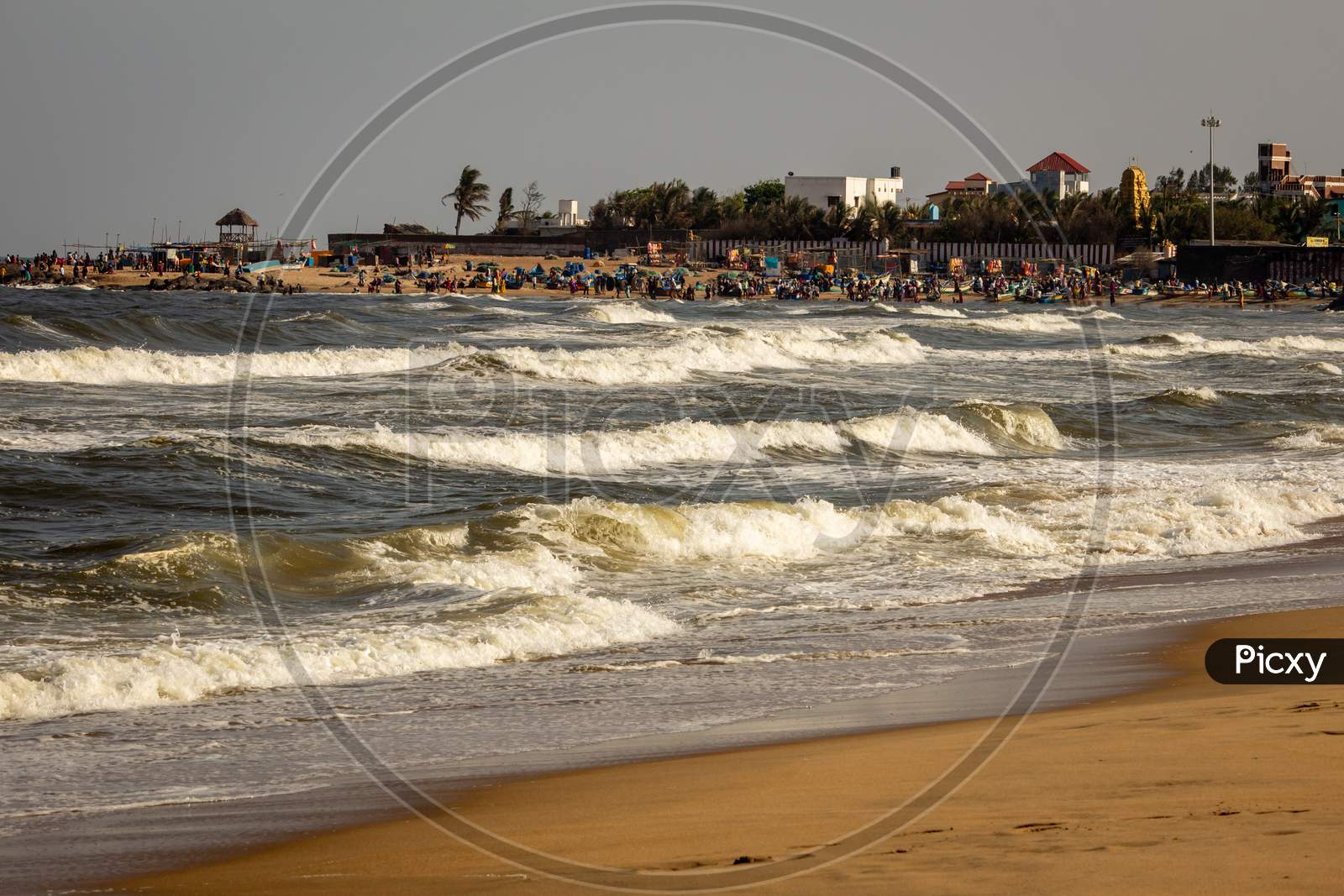 Kovalam, Tamil Nadu, India - February 04 2021: Scenic View Of The Waves And People Having Fun Along The Kovalam Beach, Chennai, India.
