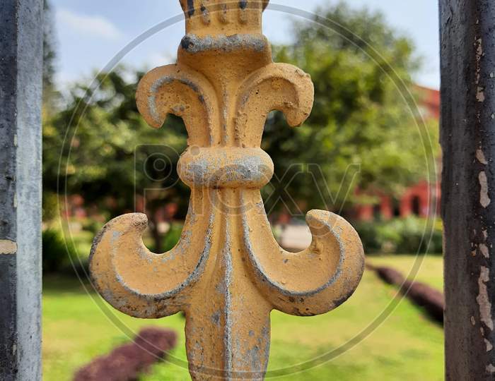 Beautiful Gold And Black Color Iron Gate Railing Like Trident Or Flower Shape Design In A Nature Background
