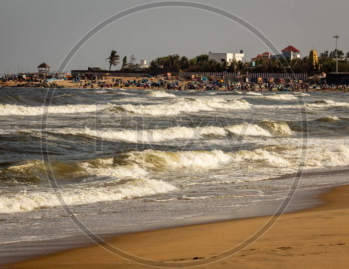 Kovalam, Tamil Nadu, India - February 04 2021: Scenic View Of The Waves And People Having Fun Along The Kovalam Beach, Chennai, India.