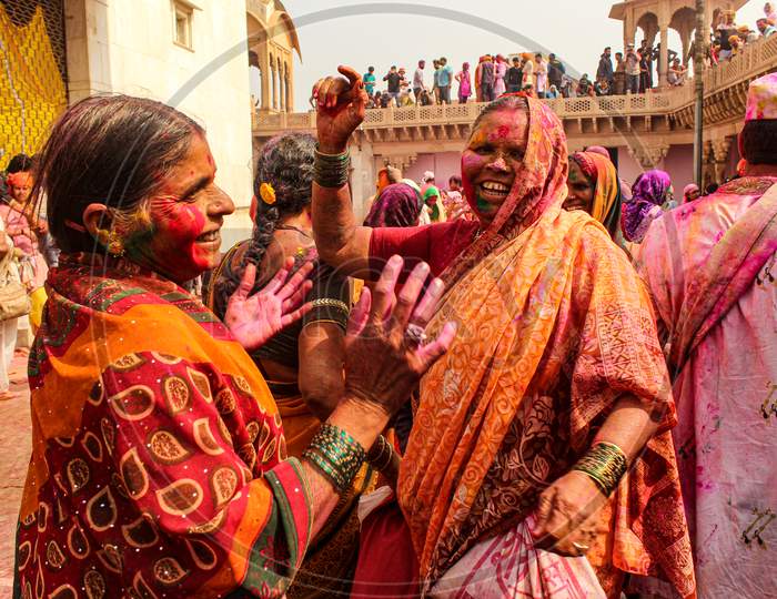 Mathura, Uttar Pradesh, India- January 28 2020: Two Widowed Women Roaming Around The Temple In Nandgaon During The Festival Of Holi. Widow Women Playing Holi In Mathura.