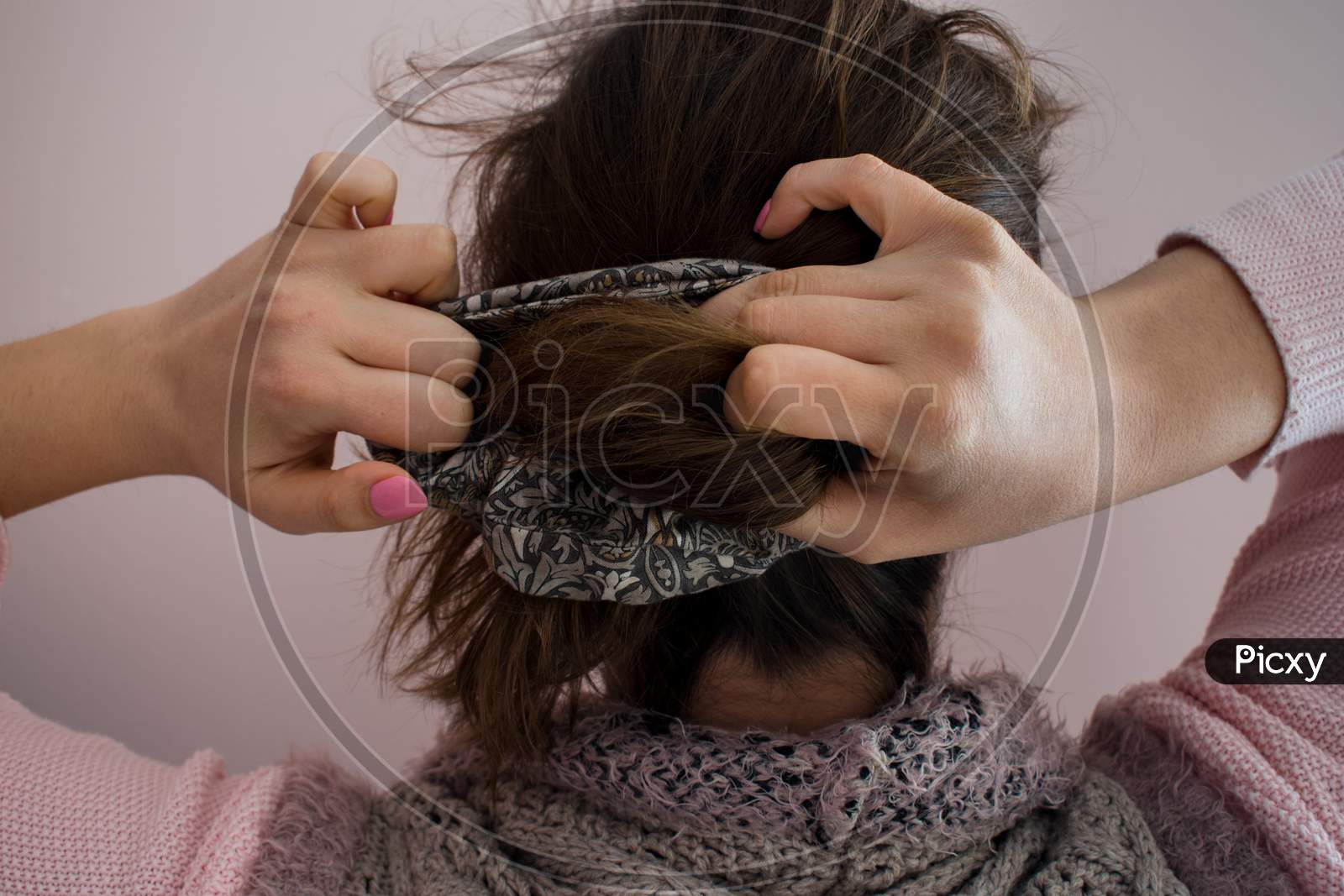 Young Woman Doing A Ponytail With A Scrunchie Hair Tie