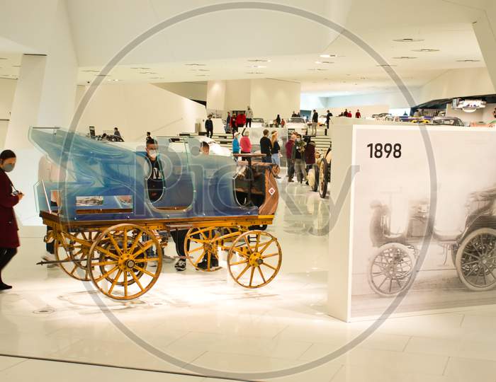 People Looking At Vintage Cars In The Porsche Museum In Stuttgart, Germany During The Covid 29 Pandemic.