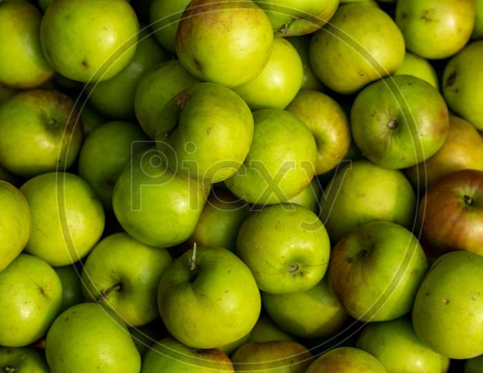 Sour Green Plums Close-Up Shot On A Shop Or Apple Kul
