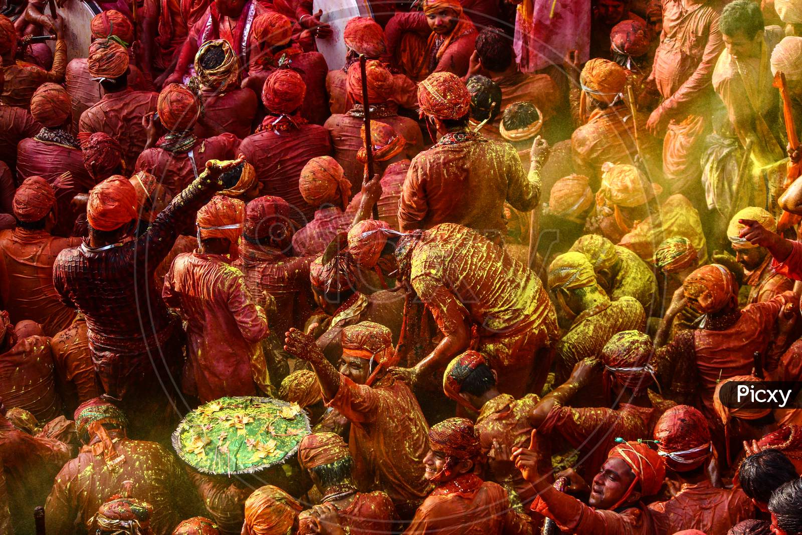 Barsana, Uttar Pradesh, India February 6 2021: People Of India Celebrating Holi In The Holy State Of Mathura. Lathmaar Holi Being Played In Nandgaon. People Covered In Colors.