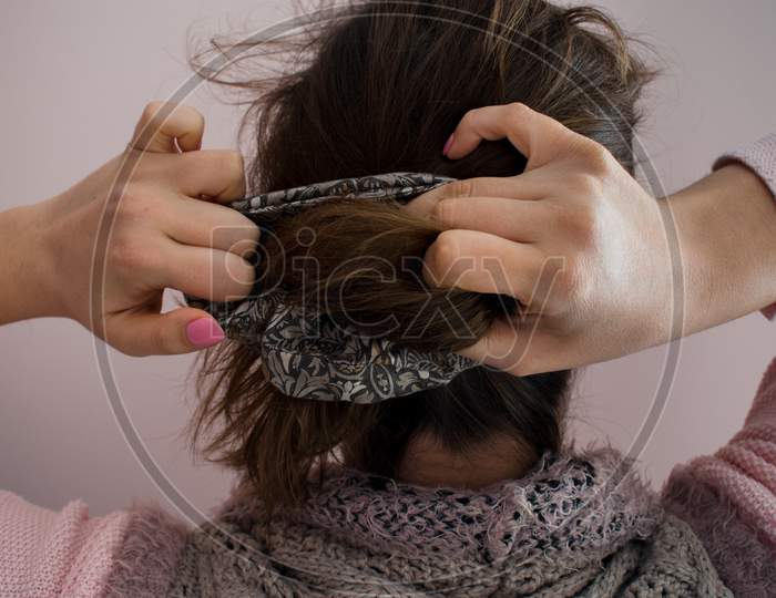 Young Woman Doing A Ponytail With A Scrunchie Hair Tie