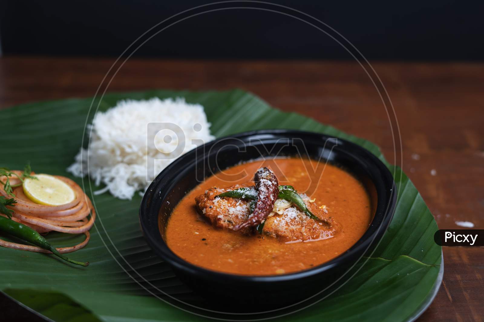 Indian Fish Curry With Rice Served On Banana Leaf,