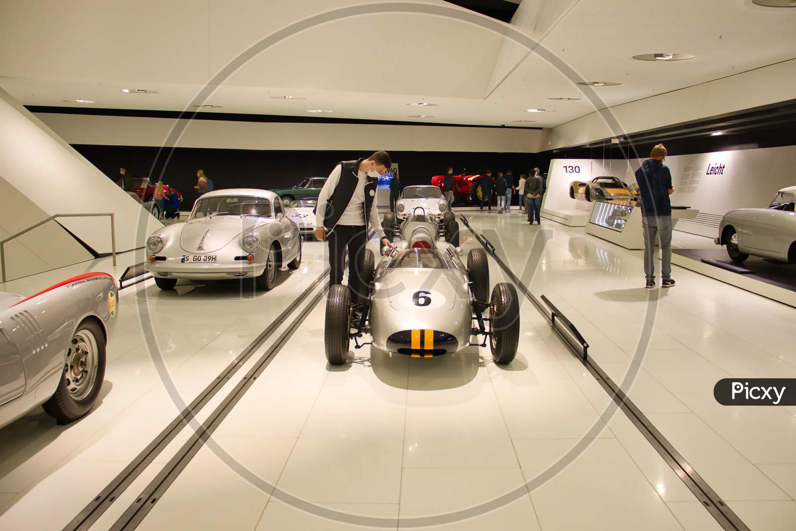 Man Looking At A Vintage Racing Car On Display In The Porsche Museum In Stuttgart, Germany.