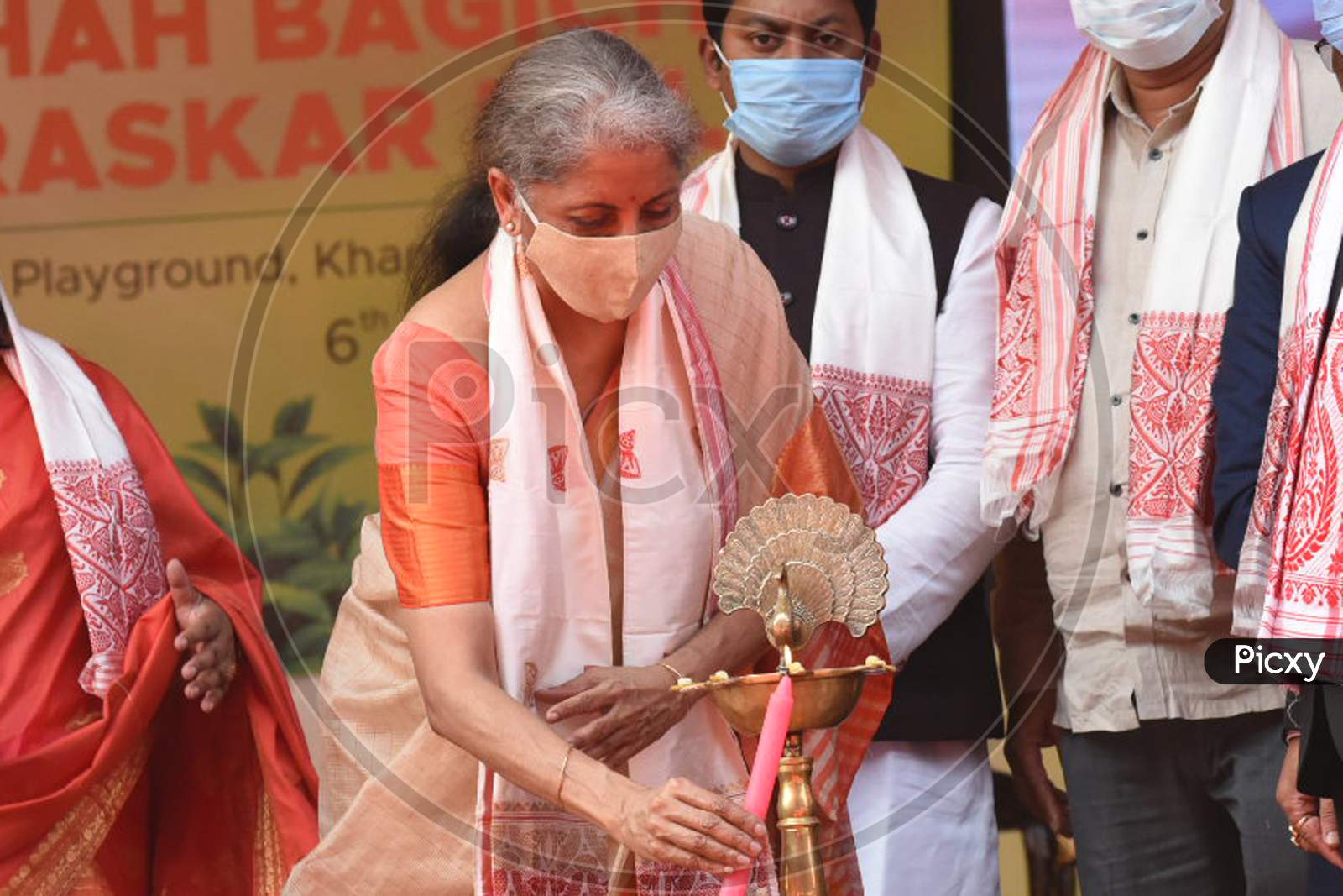 Union Finance Minister Nirmala Sitharaman light the lamp launches Chah Bagicha Dhan Puraskar Scheme during the public meeting at Khanapara Veterinary Ground in Guwahati on Saturday, 06 February 2021