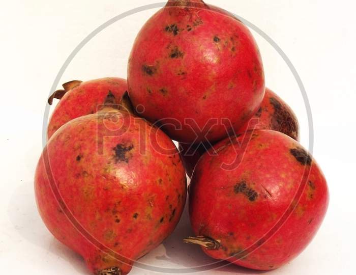 Ripe pomegranate, Punica granatum, fruit isolated on white background, fresh red pomegranate