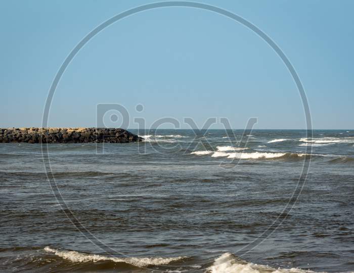 Beautiful View Of Waves And The Rock Bridge Where Backwaters And Sea Meet Along Kovalam Beach, Chennai, India