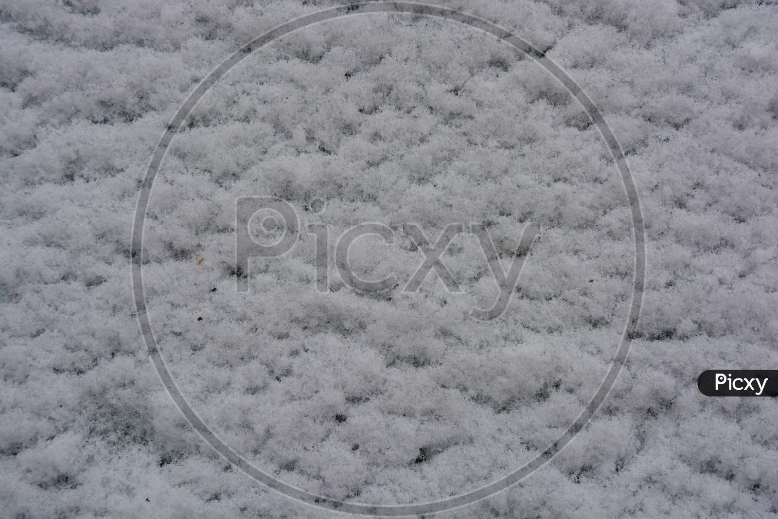 Image of Fluffy soft white snow lies on wooden planks, the first snow