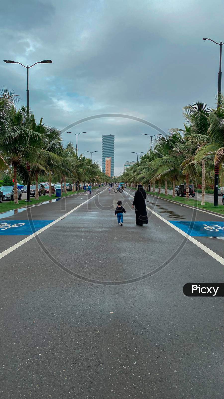 A Woman Walking With A Child On Road In Corniche, Jeddah, Saudi Arabia, 2021