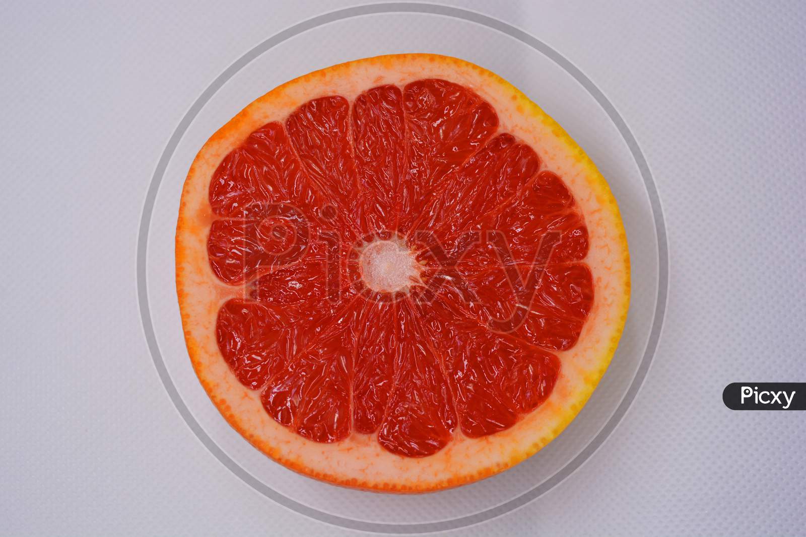 Halves of ripe juicy grapefruit, halved, set on a white background. Delicious and healthy sweet and sour fruits for the human body and health.