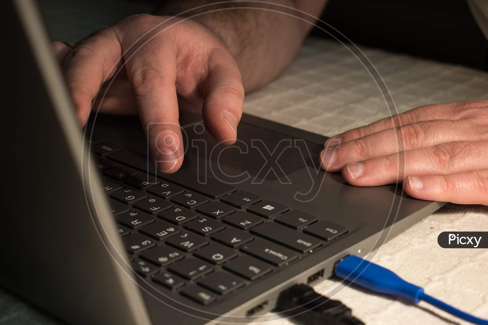 Fingers Typing On The Keyboard Of A Laptop