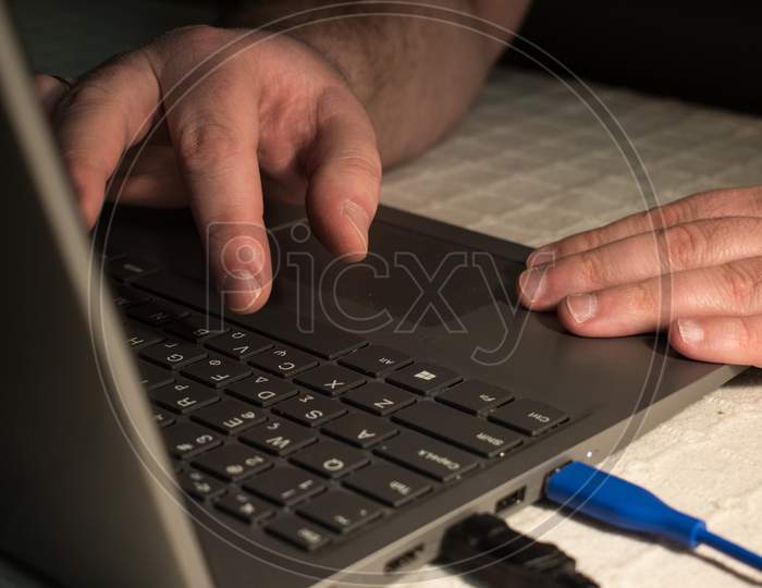 Fingers Typing On The Keyboard Of A Laptop