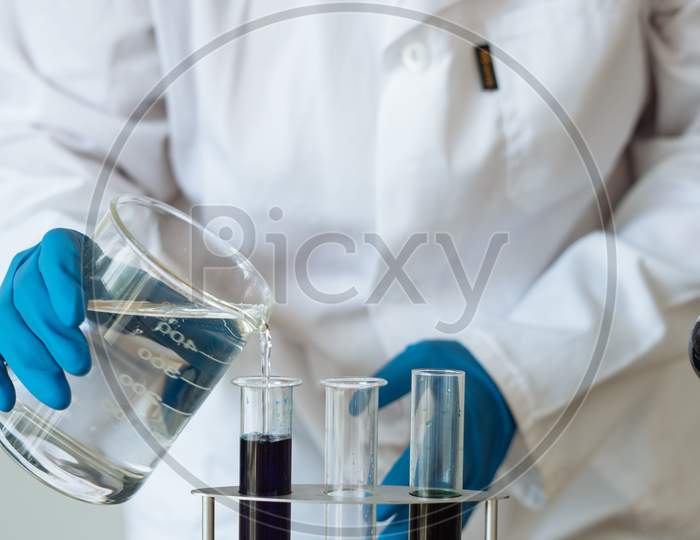Scientists Studying A Virus Looking Through Microscope Scientists In Protective Suits In A Science Laboratory Study A Virus Covid19 Blood Test