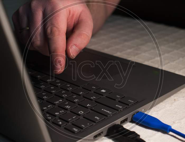 Single Finger Press Button On Laptop Keyboard.Hand On Laptop Keyboard