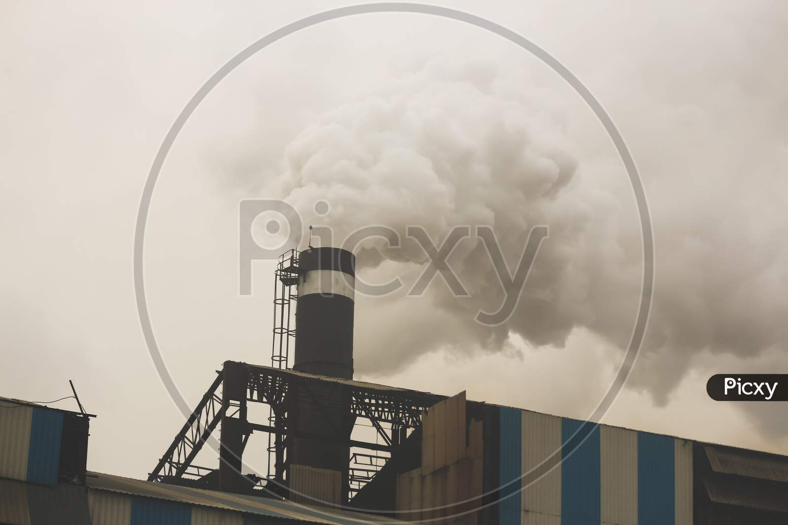 smoke coming out from the chimney of a factory industry