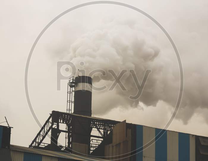smoke coming out from the chimney of a factory industry