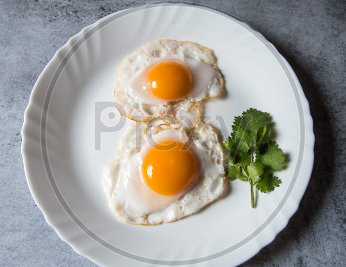 Egg poach sunny side up a healthy food ingredient on a plate.