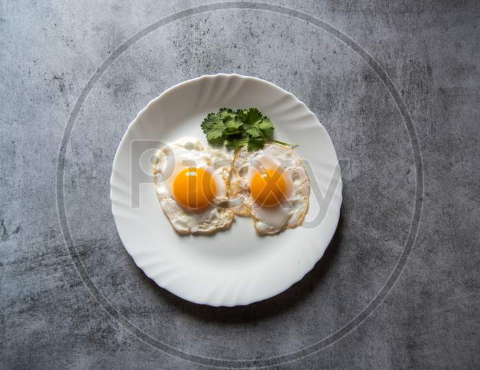 Egg poach sunny side up a healthy food ingredient on a plate.