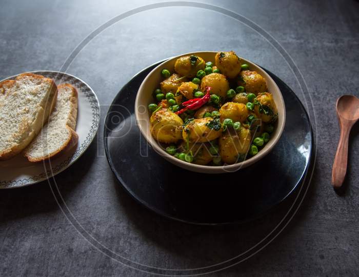 Aloo dum or steamed potatoes in gravy in a bowl.