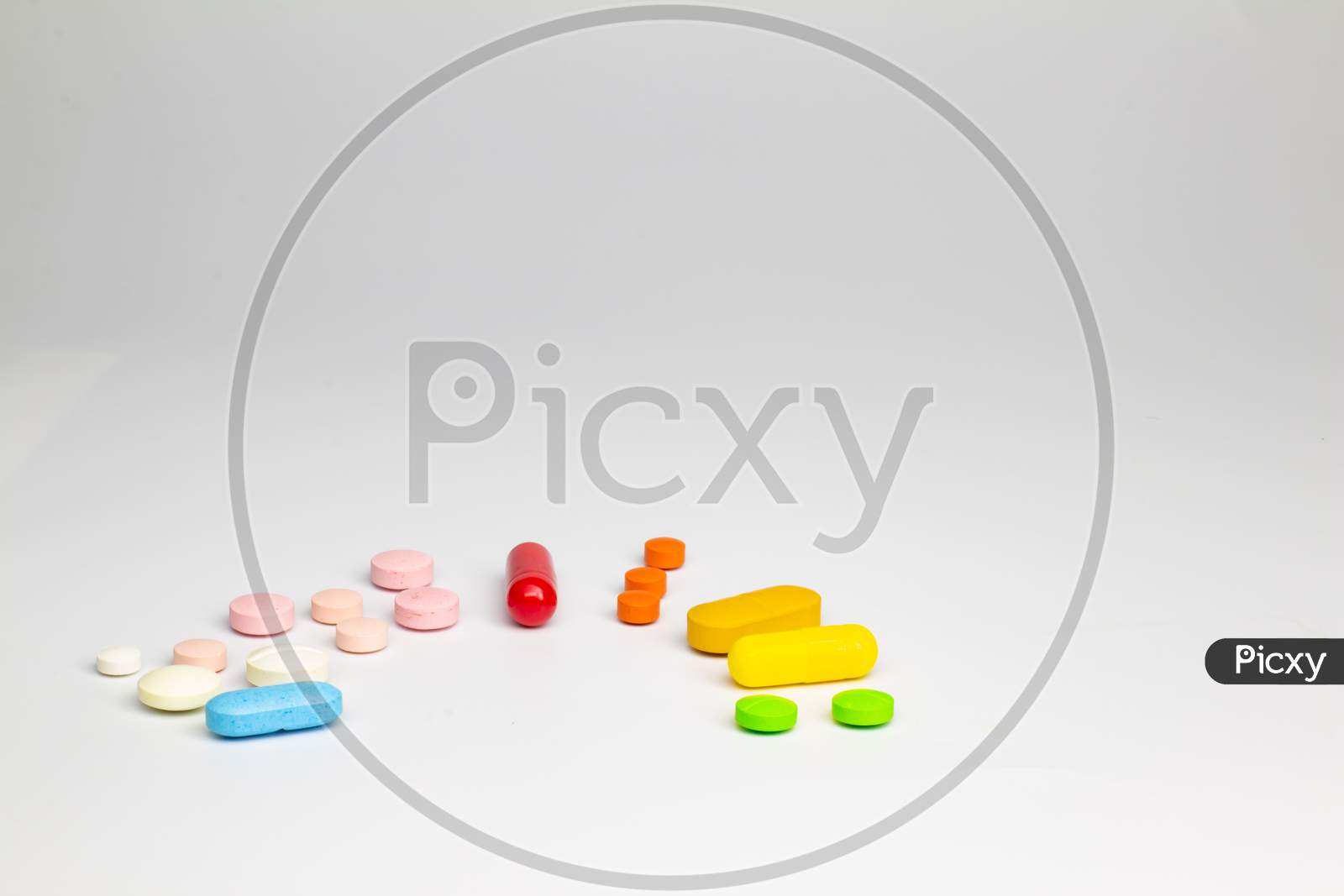 Colored Pills On A White Background With Free Space To Write. Concept Of Legal Drug Use