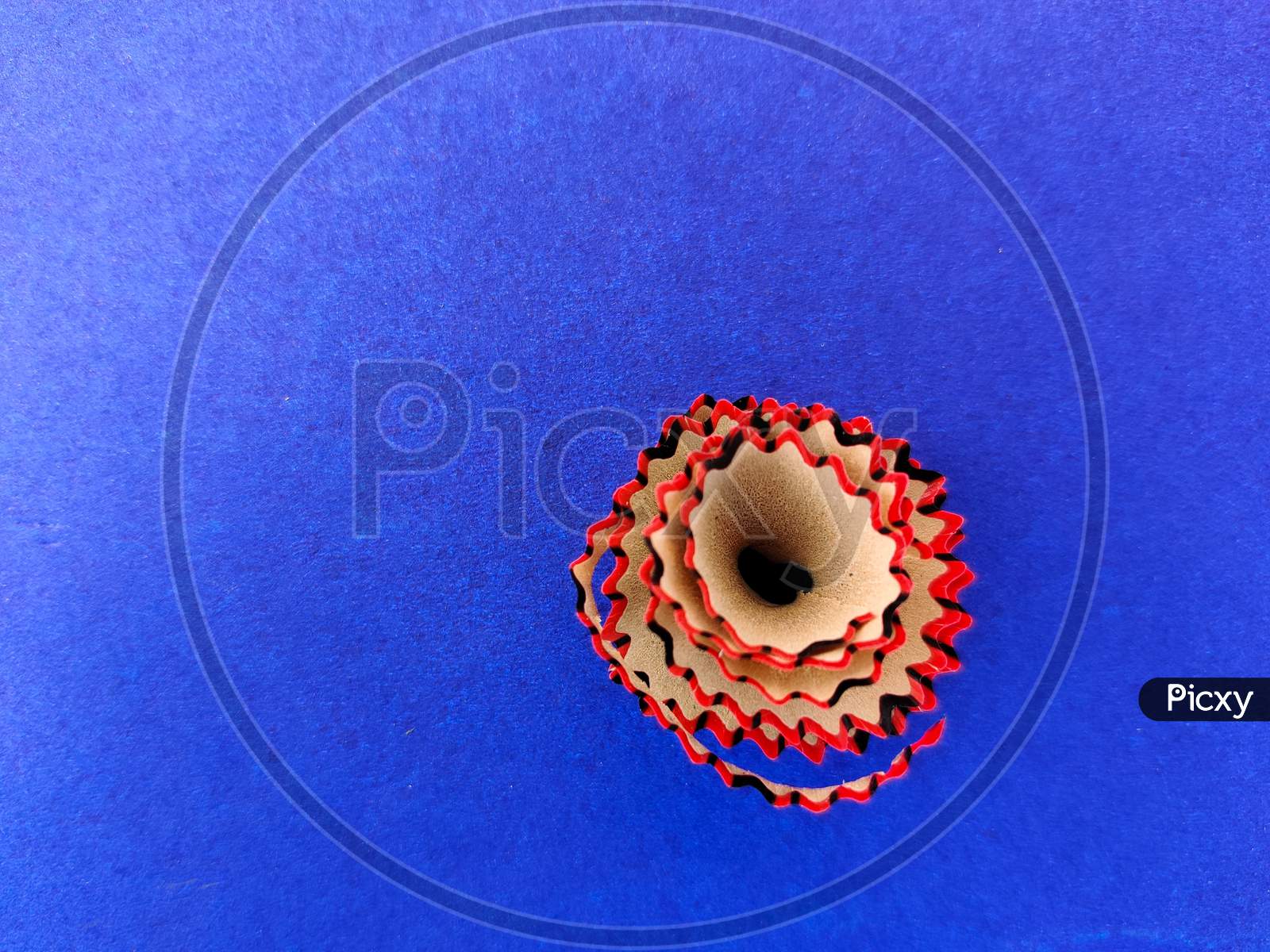 Copy Space Of Red Color Pencil Shavings Isolated On Blue Background