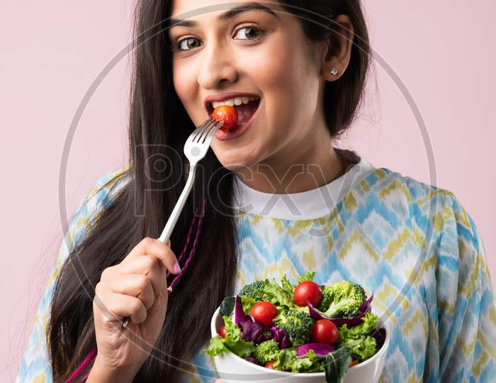 Indian Asian Young Beautiful Woman Eating Fresh Green Salad In A Bowl