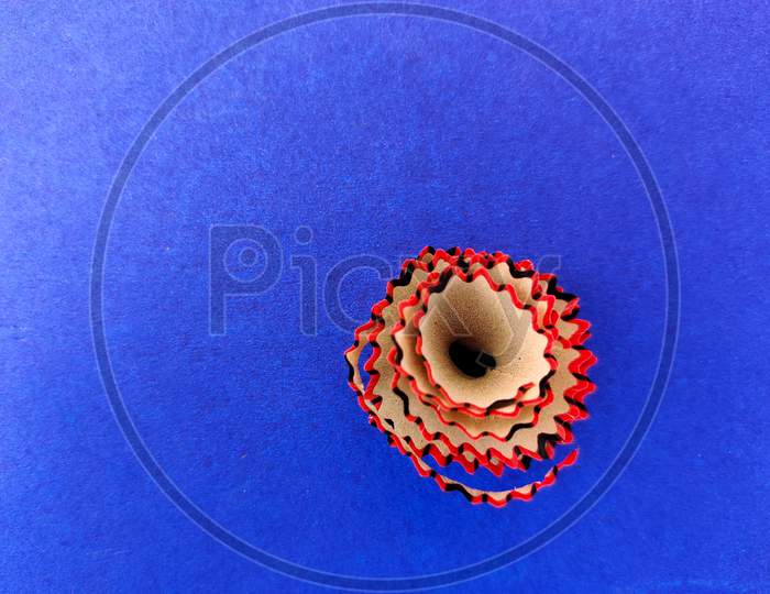 Copy Space Of Red Color Pencil Shavings Isolated On Blue Background