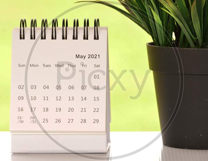 White May 2021 Calendar With Green Backgrounds And Potted Plant. 2021 New Year Concept