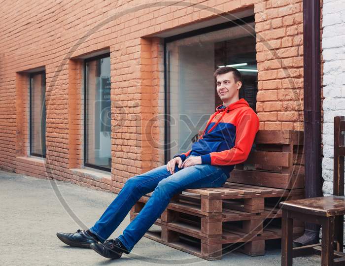 Man Sitting On A Fashionable Bench