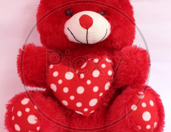 Lovely Red Teddy Bear With Red Heart On White Background