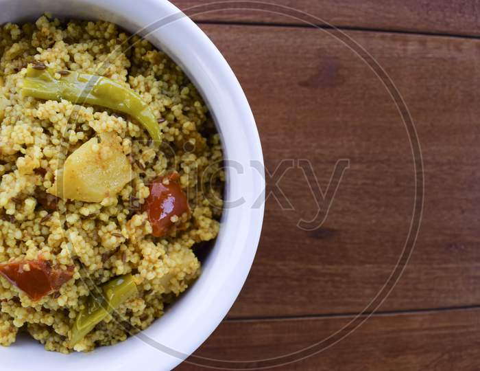 Traditional Indian Fasting Food Recipe Dish Called Bhagar Homemade Of Barnyad Millet Rice Grains. Also Known As Samo Or Sama Pulao Rice Khichdi. Indian Fasting Food Dish On Wooden Background