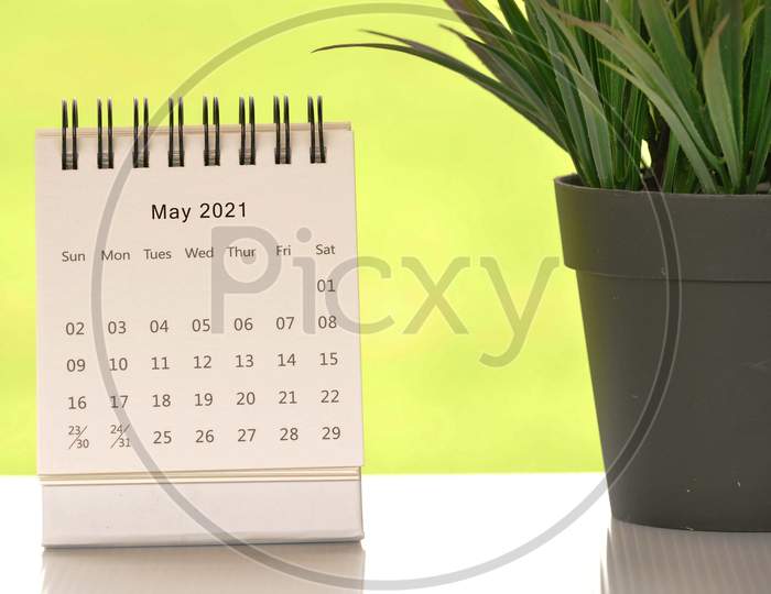 White May 2021 Calendar With Green Backgrounds And Potted Plant. 2021 New Year Concept