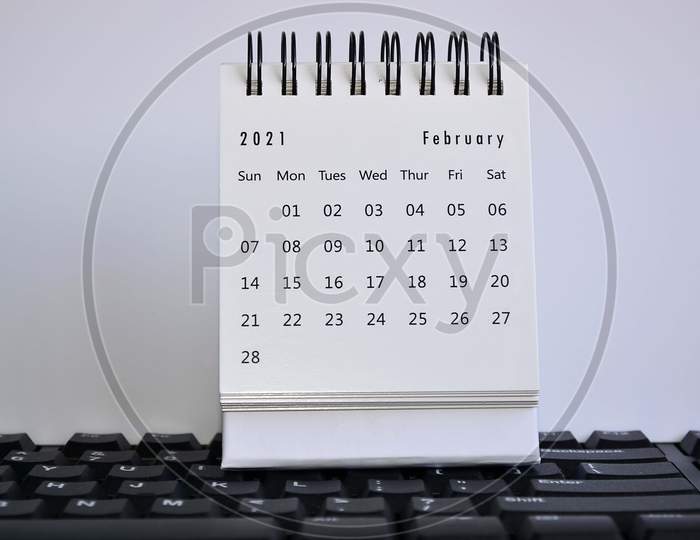 White February 2021 Calendar On A Blurred Keyboard With White Background