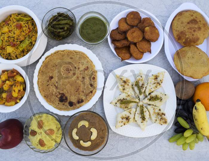 Farali Vrat Thaali Homemade Items Rajgira Sheera, Paratha, Puri Bhajiya Or Pakoda. Sabudanaflour White Dhokla, Sweetpotato Dessert Halwa, Falahar Mix Fruits, Mint Chutney, Chilly Peanut Pickle, Bhagar